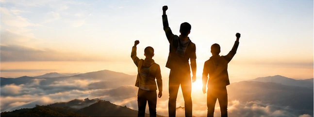 Youths celebrating on mountain top